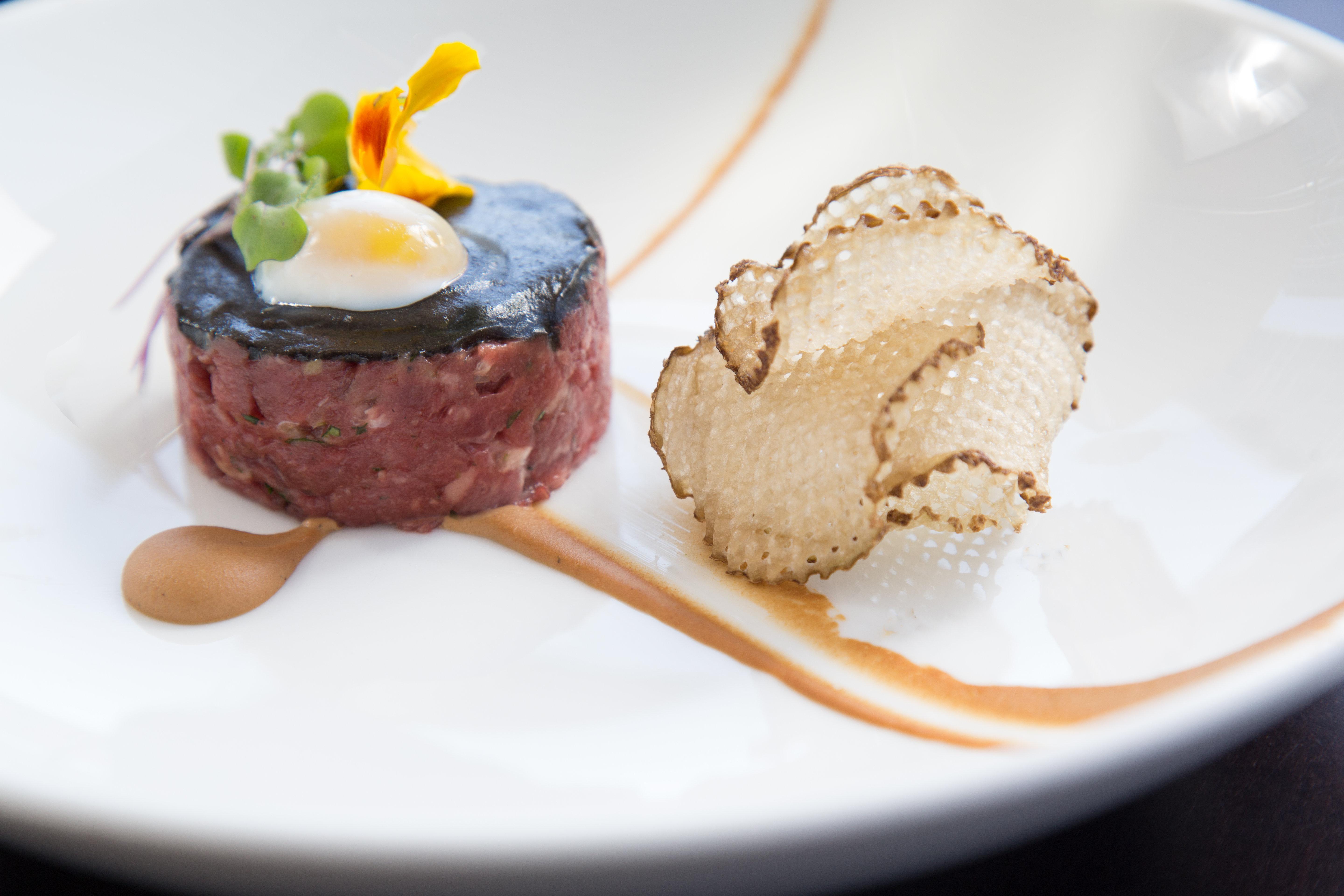 Kimpton Epic Hotel By Ihg Miami Kültér fotó A dish of beef tartar with a slice of black truffle
